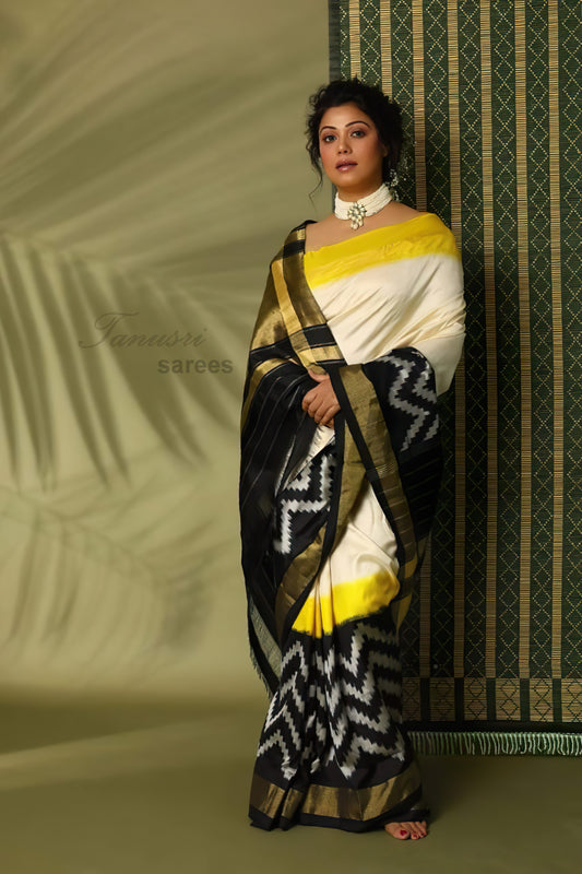 Embrace Sophistication: Cream and Black Zig Zag Border Ikat Patola Silk Saree